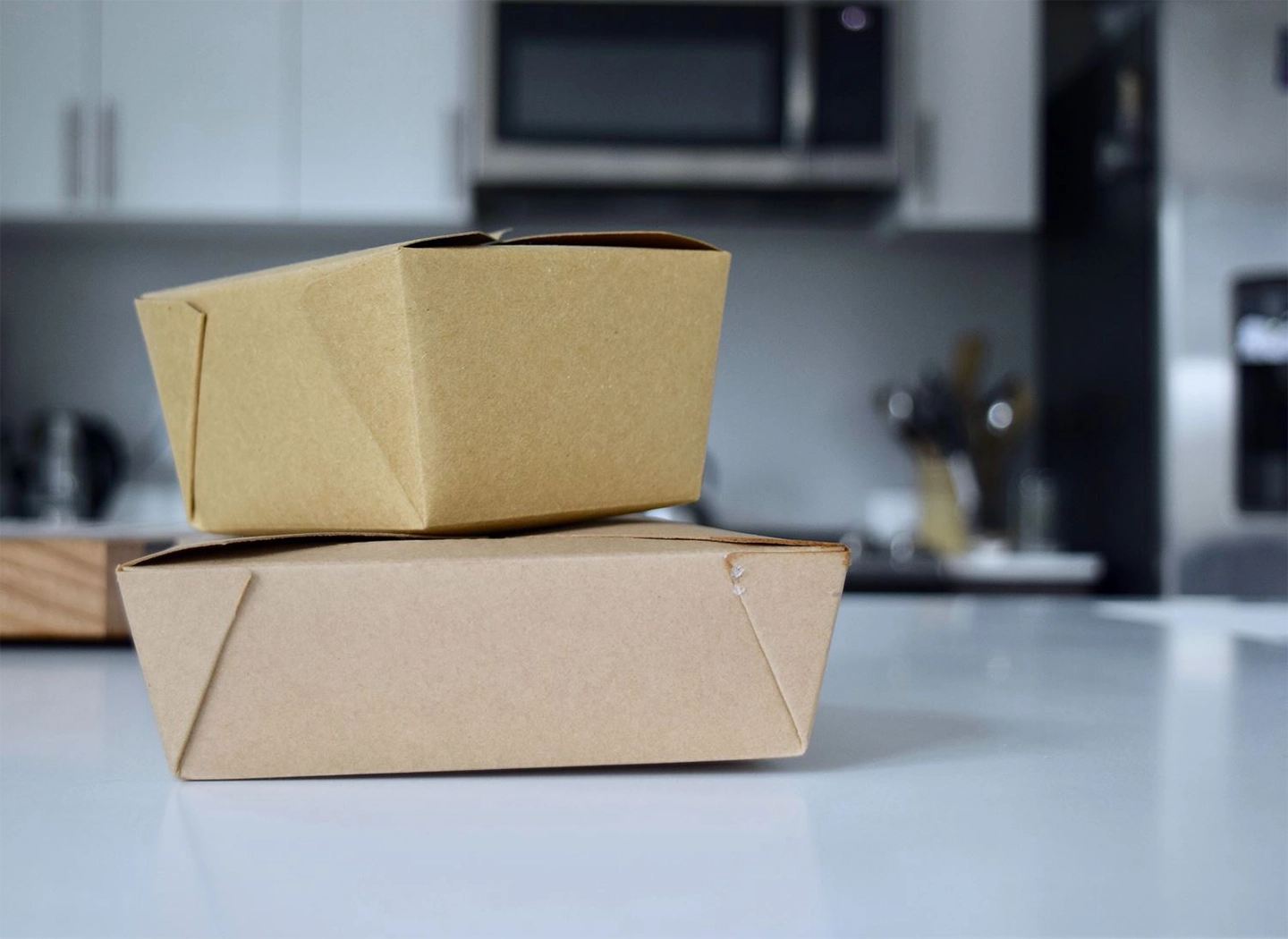 takeaway boxes stacked on a kitchen unit