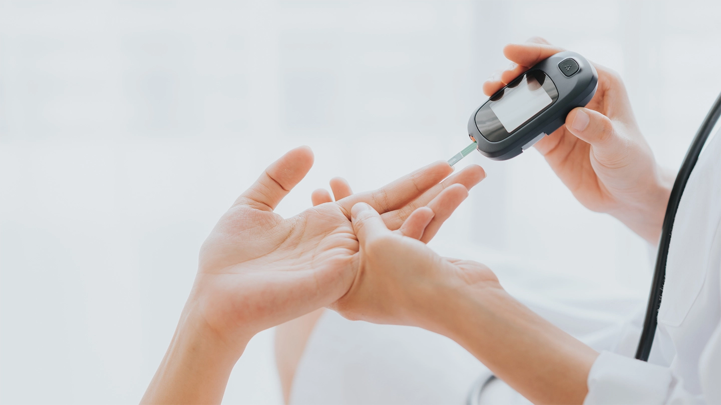 someone conducting a diabetic prick test