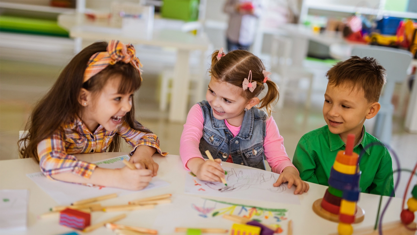 group of small children colouring in a school environment